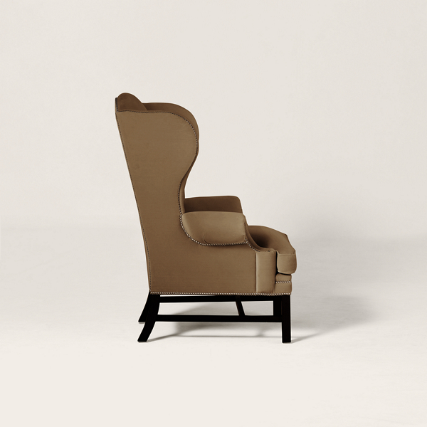 Brown wingback chair on a plain background.